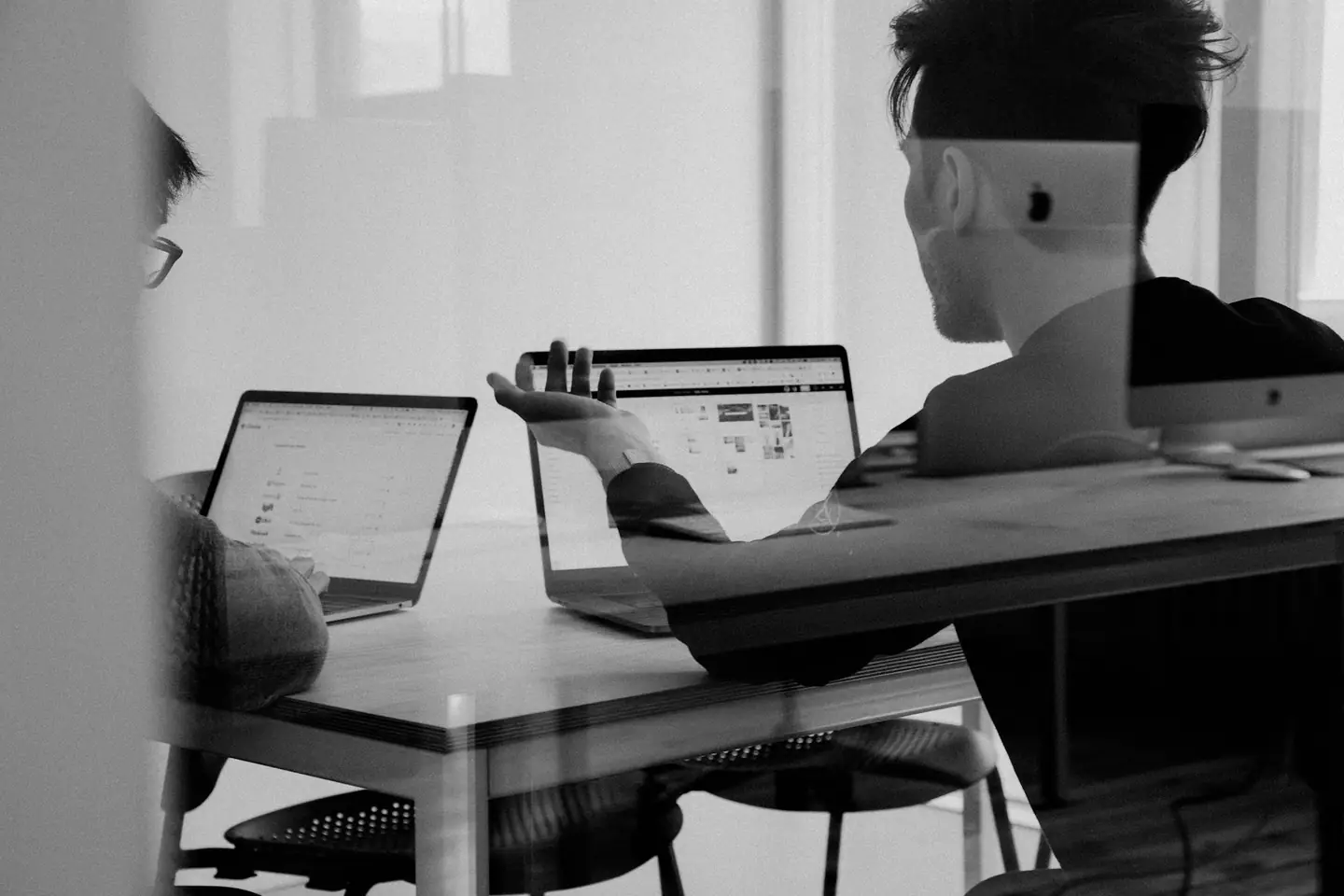 Person reading on a laptop at a quiet desk