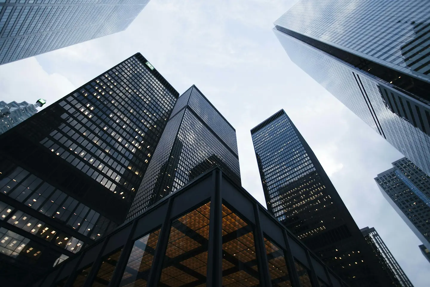 Looking up at glass office towers against the sky